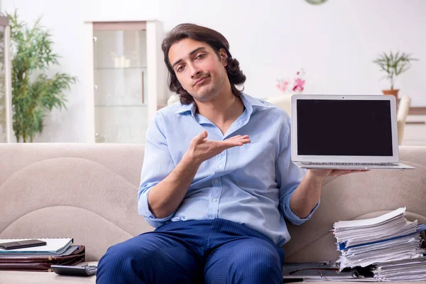 Young male employee working at home — Stock Photo, Image