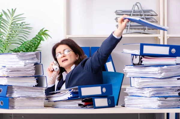 Middle-aged businesswoman unhappy with excessive work — Stock Photo, Image