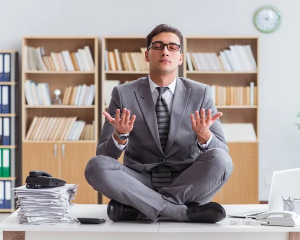 Handsome meditating on the office desk — Stock Photo, Image