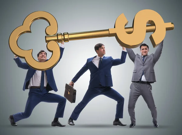 Businessmen holding giant key in finance concept — Stock Photo, Image