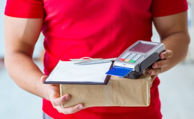 Parcel delivery being paid with pos and credit card clipart