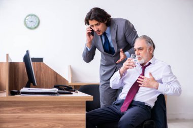 Male employee suffering from heart attack in the office clipart