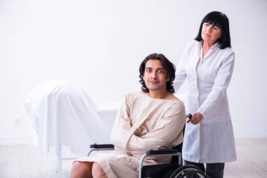 Yaşlı kadın psikiyatrist genç erkek hastayı ziyaret ediyor