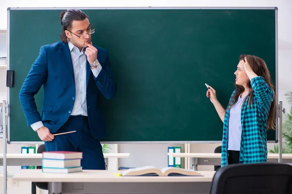 Jovem e bonita professora e estudante em sala de aula — Fotografia de Stock