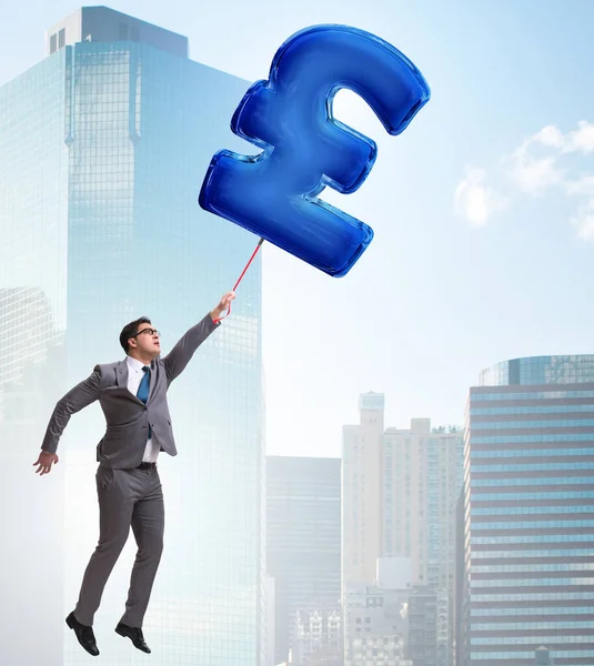 Businessman flying on british pound sign inflatable balloon — Stock Photo, Image