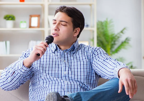 Rolig man sjunger låtar i karaoke hemma — Stockfoto