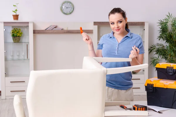 Young woman repairing chair at home — Stock Photo, Image