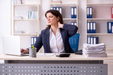 Ofiste acı çeken orta yaşlı kadın çalışan