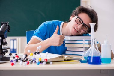 Sınıftaki genç erkek öğrenci.