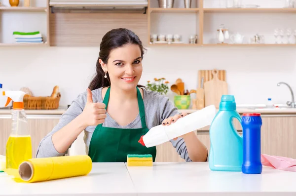 Young female contractor doing housework — Stock Photo, Image