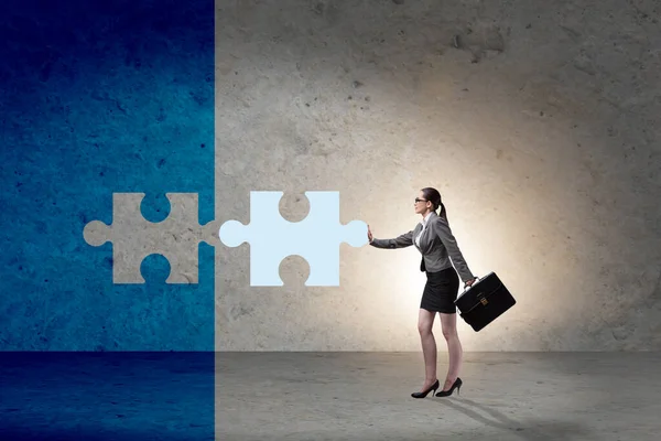 Concept of businesswoman with missing jigsaw puzzle piece — Stock Photo, Image