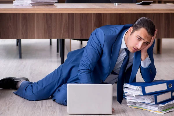 Jeune employé masculin et trop de travail au bureau — Photo