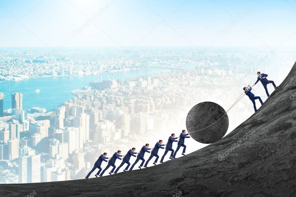 Teamwork example with business people pushing stone to top