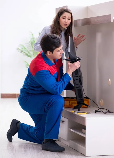 Tv repairman technician repairing tv at home