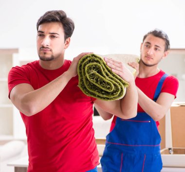 İki müteahhit personel kişisel eşyalarını taşıyor.