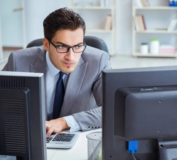 Businessman sitting in front of many screens — Stock Photo, Image