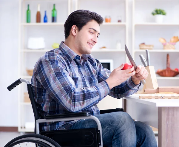 Young disabled husband preparing food salad