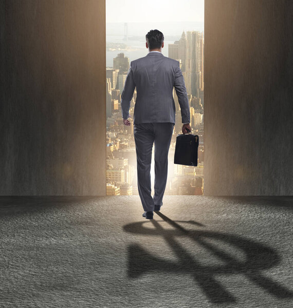 Businessman casting dollar shape shadow in business concept