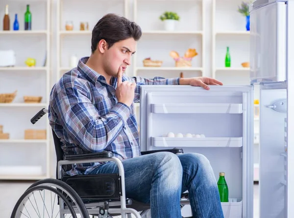 Jonge gehandicapte man die de koelkastdeur opent — Stockfoto