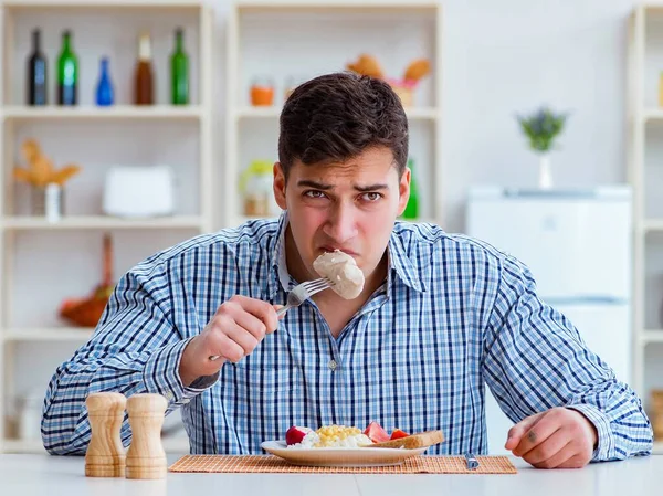Ο άνθρωπος τρώει άγευστο φαγητό στο σπίτι για μεσημεριανό — Φωτογραφία Αρχείου