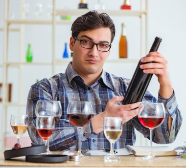 Profesyonel şarap garsonu kırmızı şarap tadıyor.