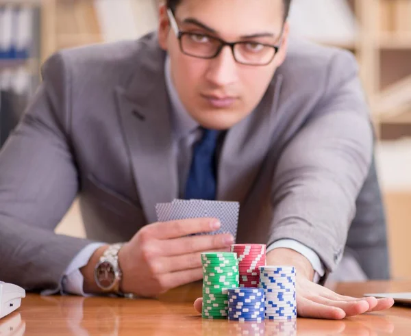 Businessman gambling playing cards at work — Stock Photo, Image