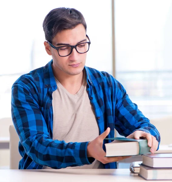 Student studying in the empty library with book preparing for ex — Stock Photo, Image