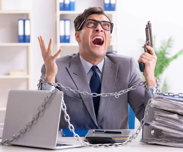 Busy employee chained to his office desk — Stock Photo, Image