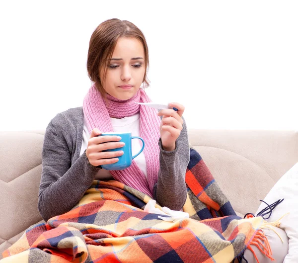 Teenager suffering from cold sitting on coach — Stock Photo, Image