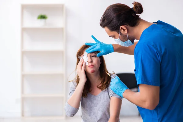 Giovane donna ferita testa visitare giovane medico maschio — Foto Stock