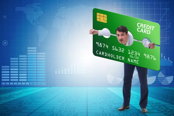 Homme d'affaires dans le concept de fardeau de carte de crédit dans pilori — Photo