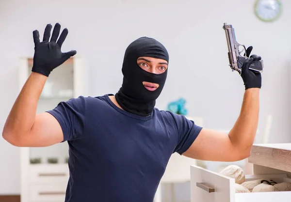 Robber wearing balaclava stealing valuable things — Stock Photo, Image