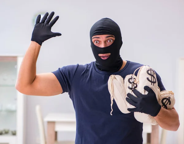 Robber wearing balaclava stealing valuable things — Stock Photo, Image