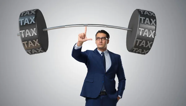 Businessman under heavy burden of taxes — Stock Photo, Image