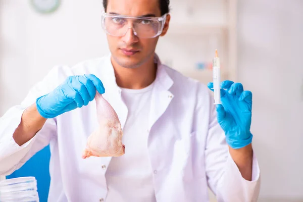 Young male nutrition expert testing food products in lab