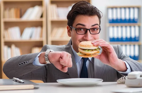 Hungrig rolig affärsman äter skräpmat smörgås — Stockfoto