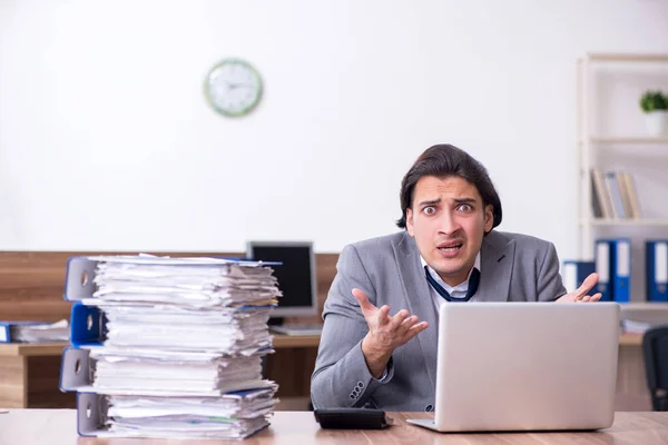 Young male employee unhappy with excessive work — Stock Photo, Image