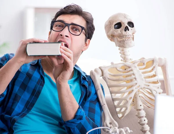 Étudiant étudiant avec squelette se préparant aux examens — Photo