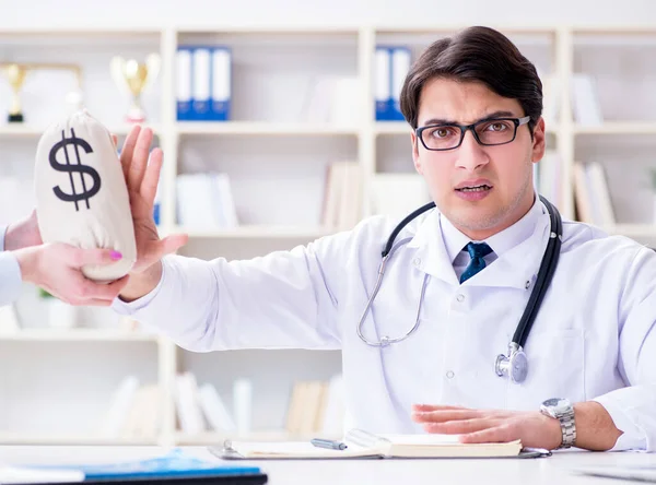 Young doctor in medical insurance fraud concept — Stock Photo, Image