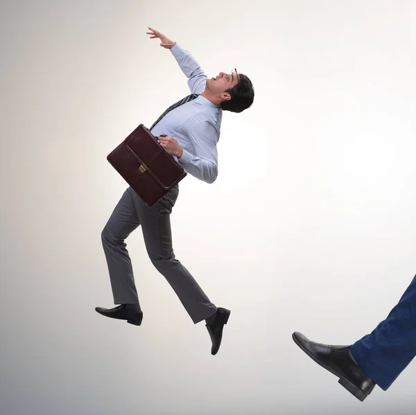 Bad angry boss kicking employee in business concept — Stock Photo, Image