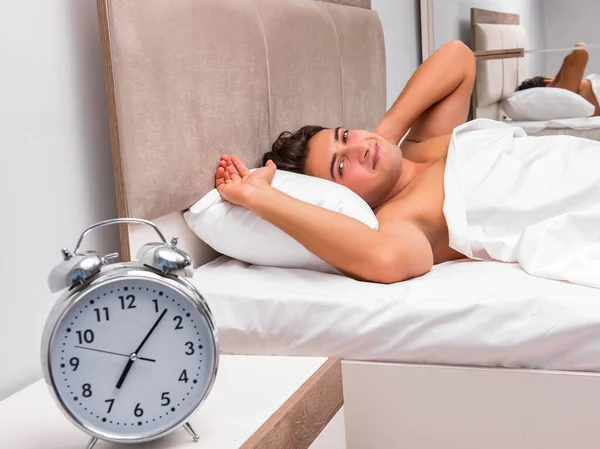 Man having trouble waking up in the morning