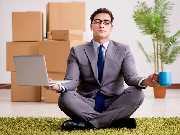 Businessman meditating on the office floor — Stock Photo, Image