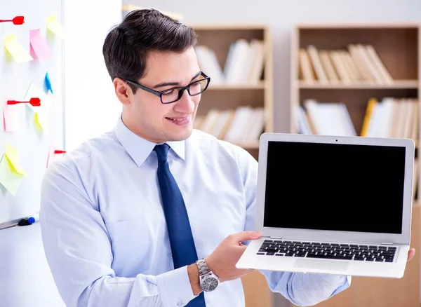 Young businessman demonstrating the screen of his laptop — Stock Photo, Image