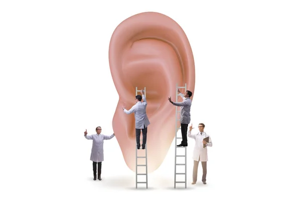 Doctor examining giant ear in medical concept — Stock Photo, Image