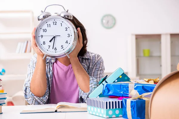 Young male student preparing for exams during Christmas — Stockfoto