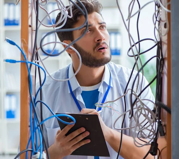 Electrician trying to untangle wires in repair concept — Stock Photo, Image