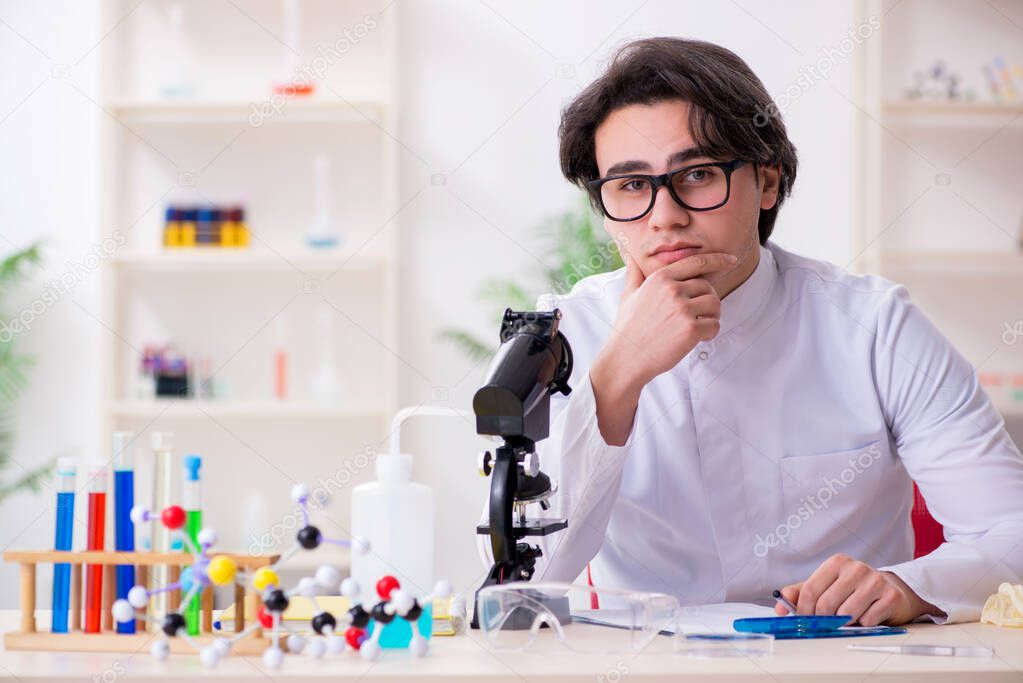 Young male biochemist working in the lab