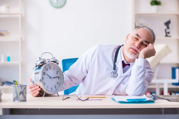 Klinikte çalışan yaşlı erkek doktor. — Stok fotoğraf