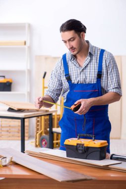 Genç erkek marangoz içeride çalışıyor.