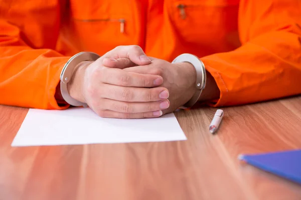 Young man writing letter in provisional detention — Stock Photo, Image